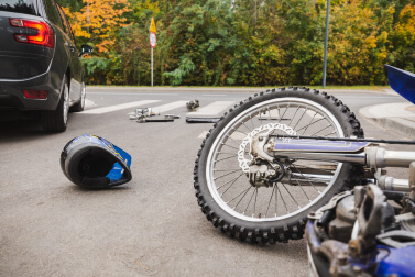 motorcycle and helmet on the road after car accident.