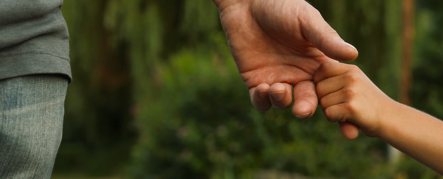 the child holds the hand of the parent.