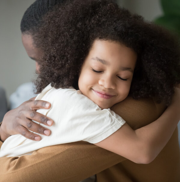 hugs of a child with his father after a divorce.