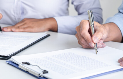 signing papers in an office.